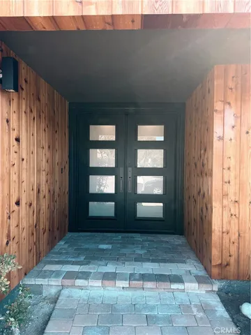 a view of a sink a microwave and window in a room