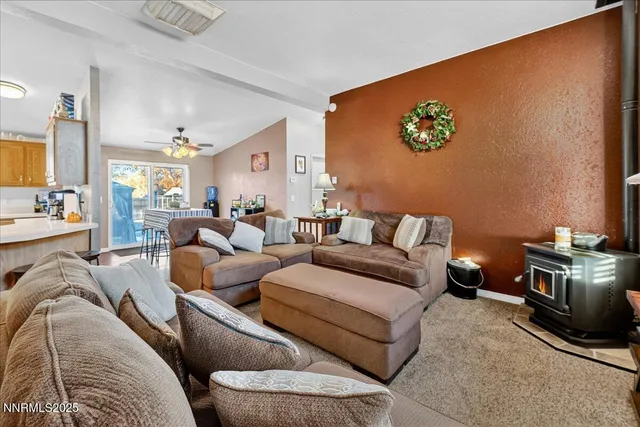 a living room with furniture and kitchen view