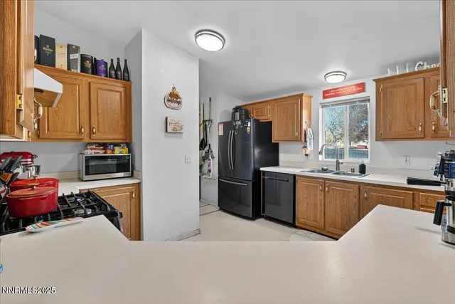 a kitchen with stainless steel appliances granite countertop a refrigerator and a sink