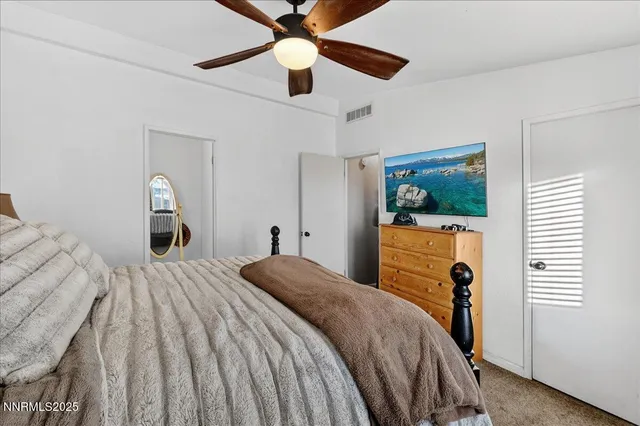 a bathroom with a toilet and a mirror