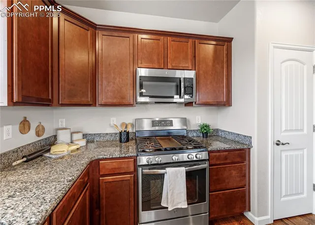 a living room with furniture a window and wooden floor
