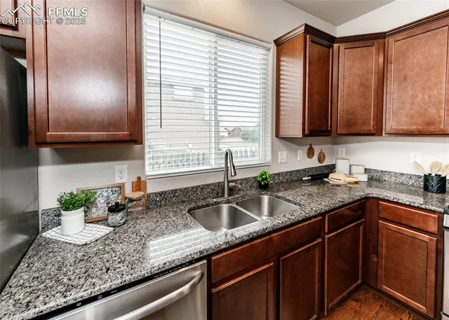 a living room with furniture a window and wooden floor