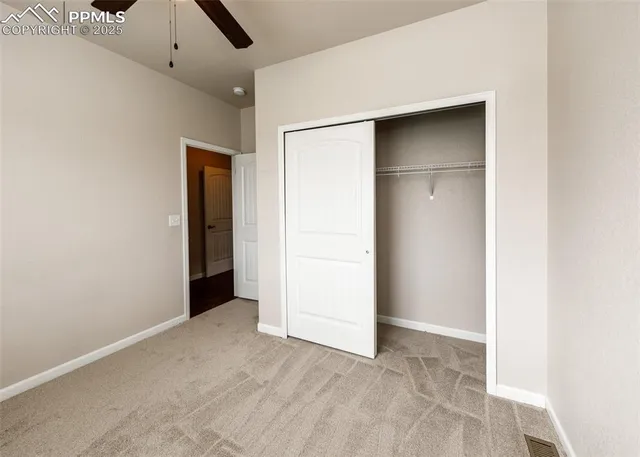 an empty room with closet and entryway
