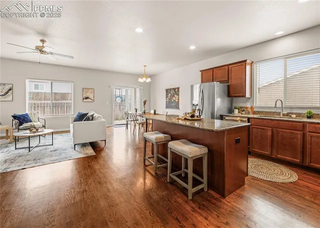 a kitchen with granite countertop wooden cabinets and a stove top oven