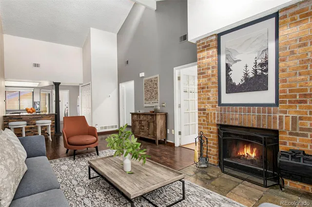 a living room with furniture a rug and a fireplace