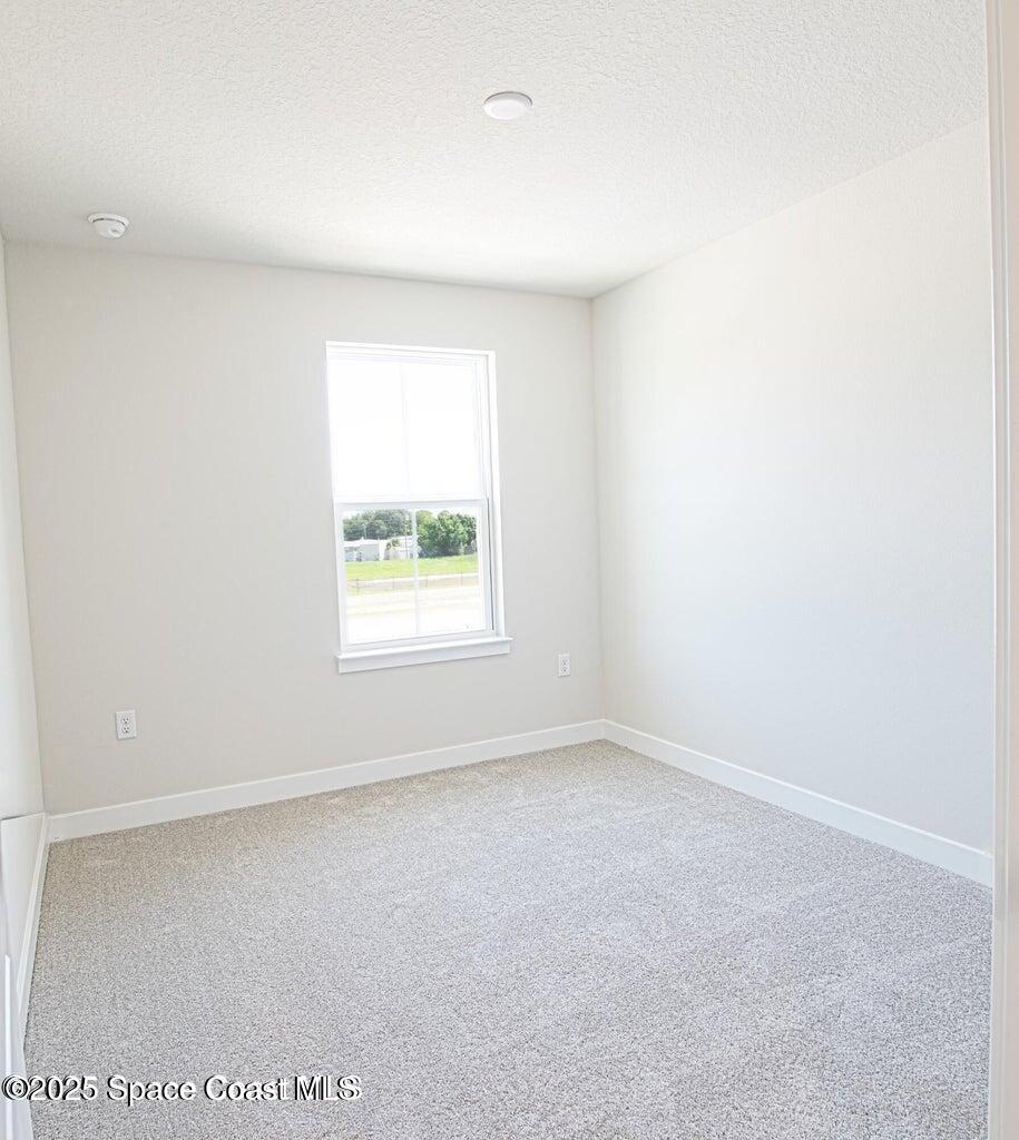 1865 Kendall Pointe Place Melbourne, FL 32935 - Photo 11 of 15 an empty room with a window