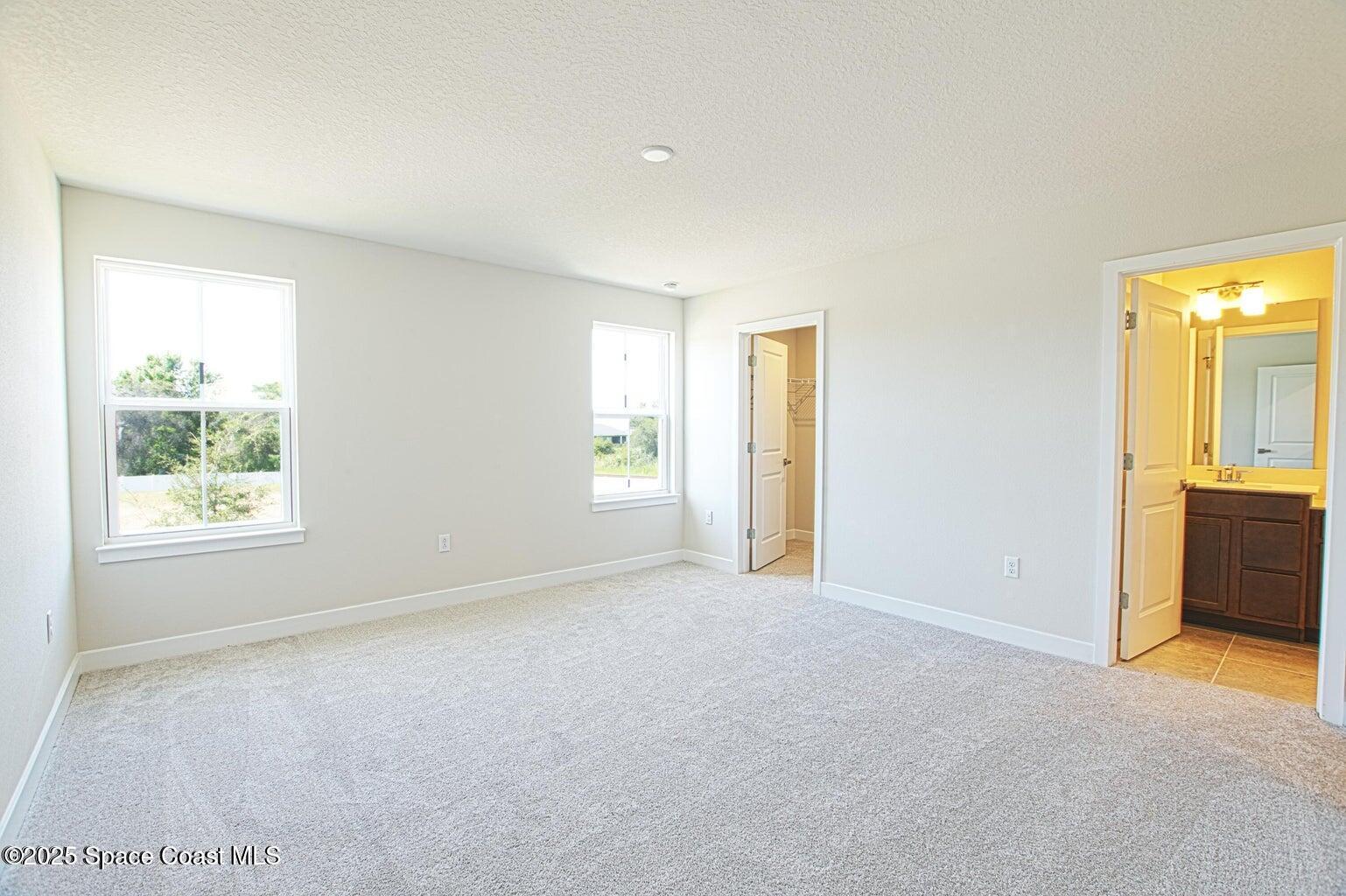 1865 Kendall Pointe Place Melbourne, FL 32935 - Photo 4 of 15 a view of an empty room with a window