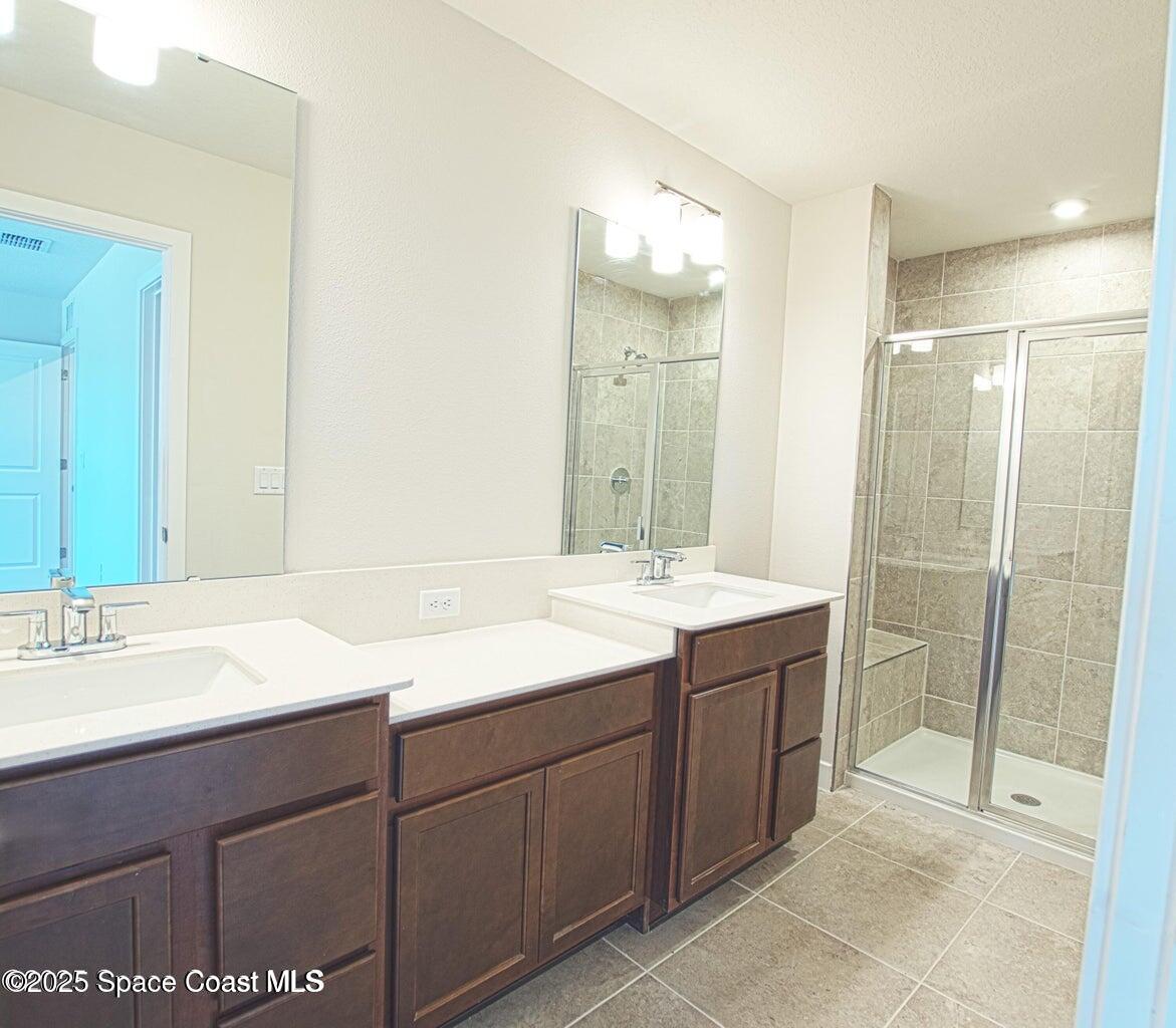 1865 Kendall Pointe Place Melbourne, FL 32935 - Photo 6 of 15 a bathroom with a double vanity sink mirror and shower