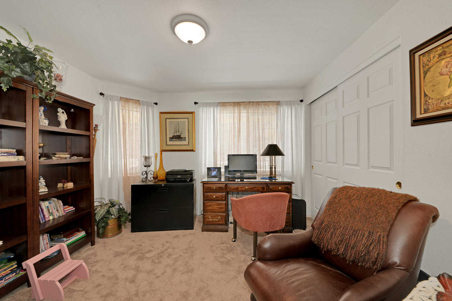 52311 Ammon Road La Pine, OR 97739 - Photo 17 of 39 a work room with furniture a bookshelf and a window