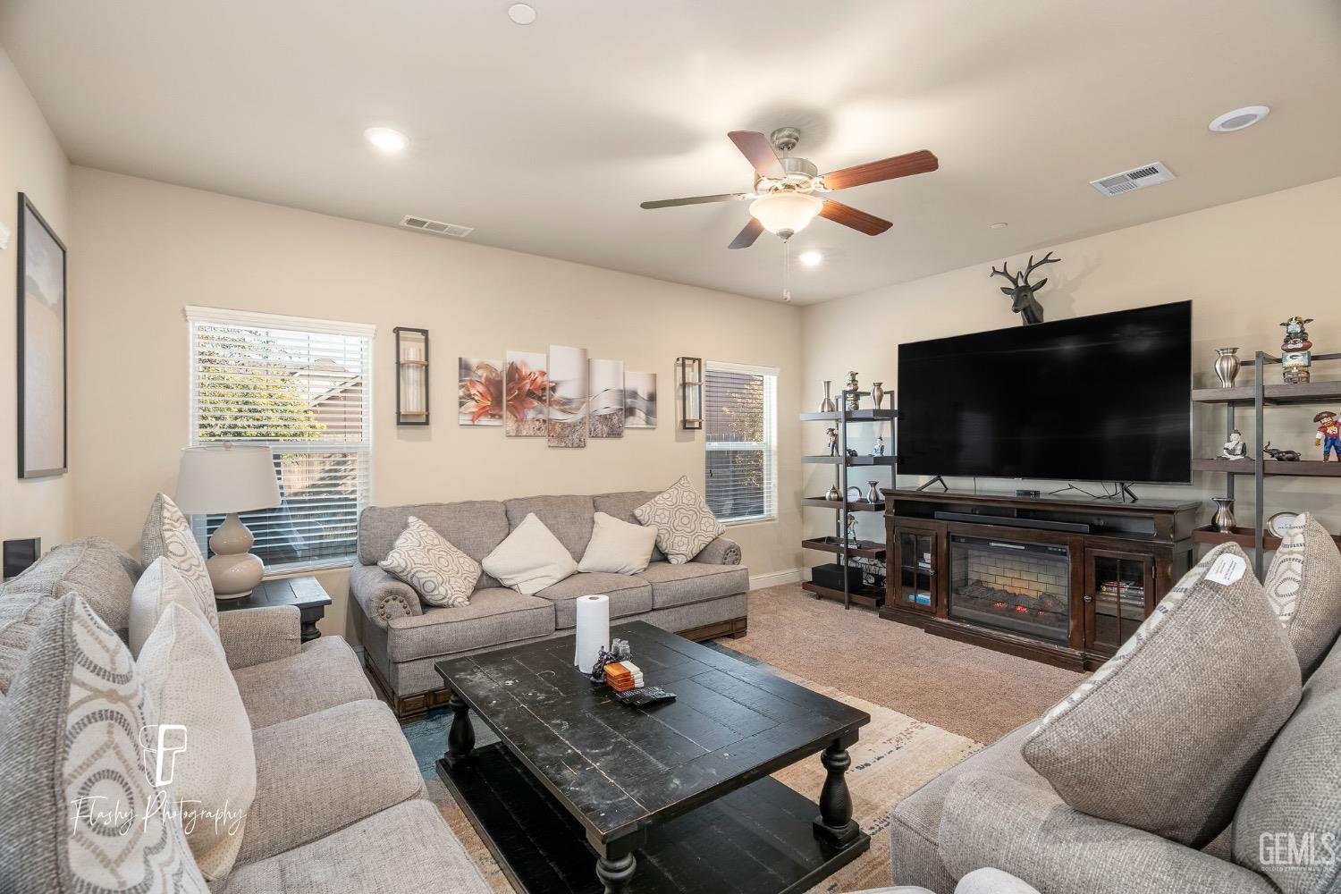 Undisclosed Address Bakersfield, CA 93313 - Photo 20 of 36 a living room with furniture and a flat screen tv