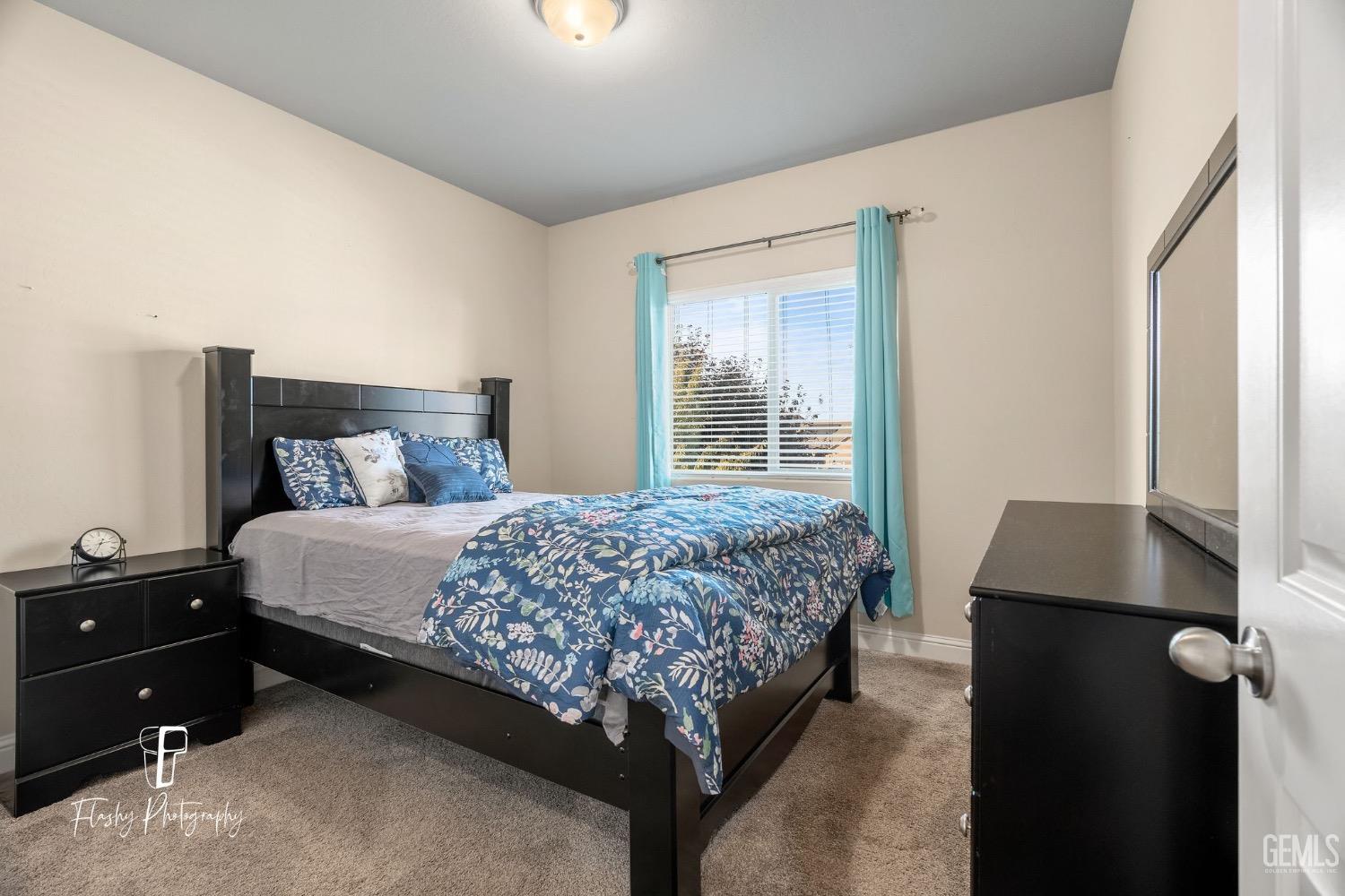 Undisclosed Address Bakersfield, CA 93313 - Photo 25 of 36 a bedroom with a bed and a window