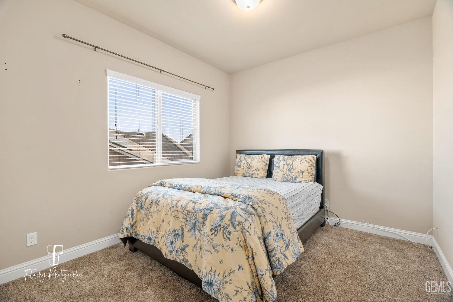 Undisclosed Address Bakersfield, CA 93313 - Photo 26 of 36 a bedroom with a bed and window