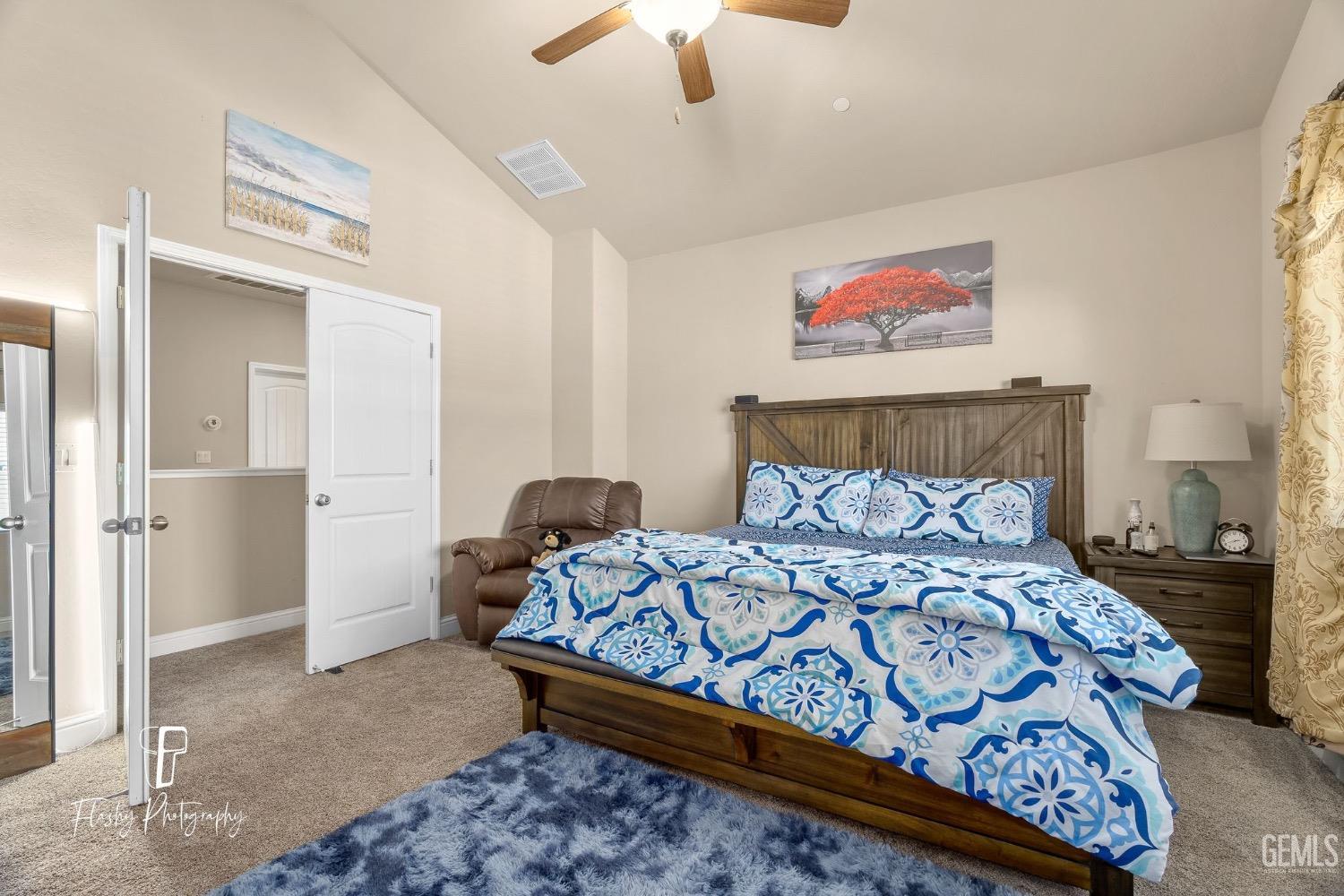 Undisclosed Address Bakersfield, CA 93313 - Photo 28 of 36 a bedroom with a bed and a chandelier