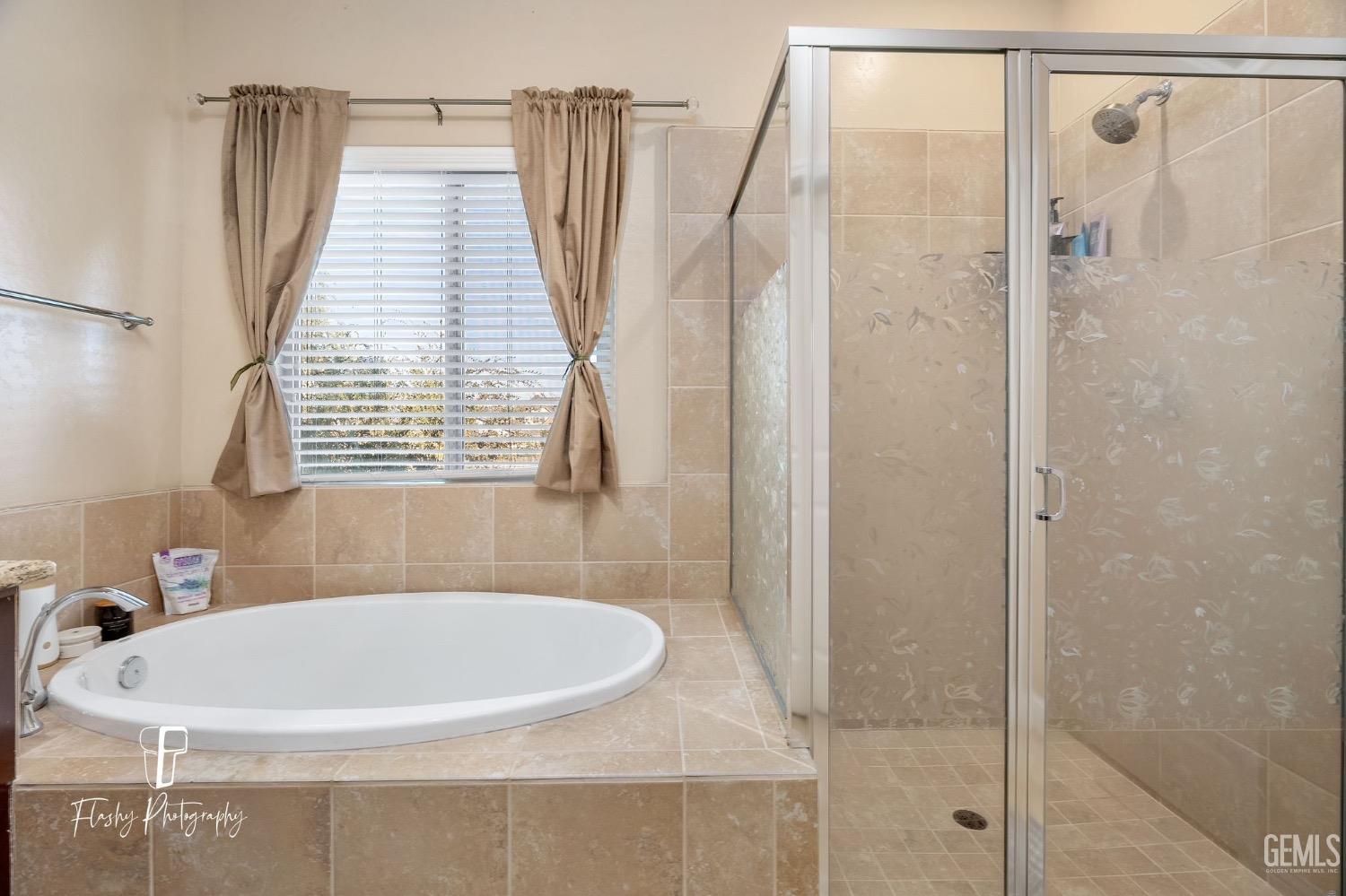 Undisclosed Address Bakersfield, CA 93313 - Photo 31 of 36 a bath tub sitting next to a bathroom sink