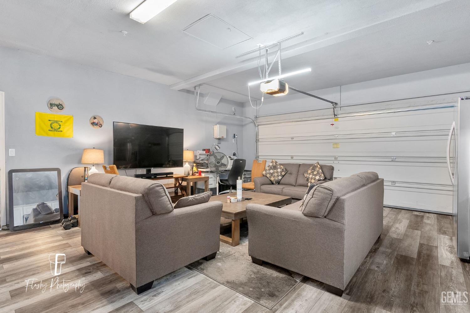Undisclosed Address Bakersfield, CA 93313 - Photo 32 of 36 a living room with furniture and a flat screen tv