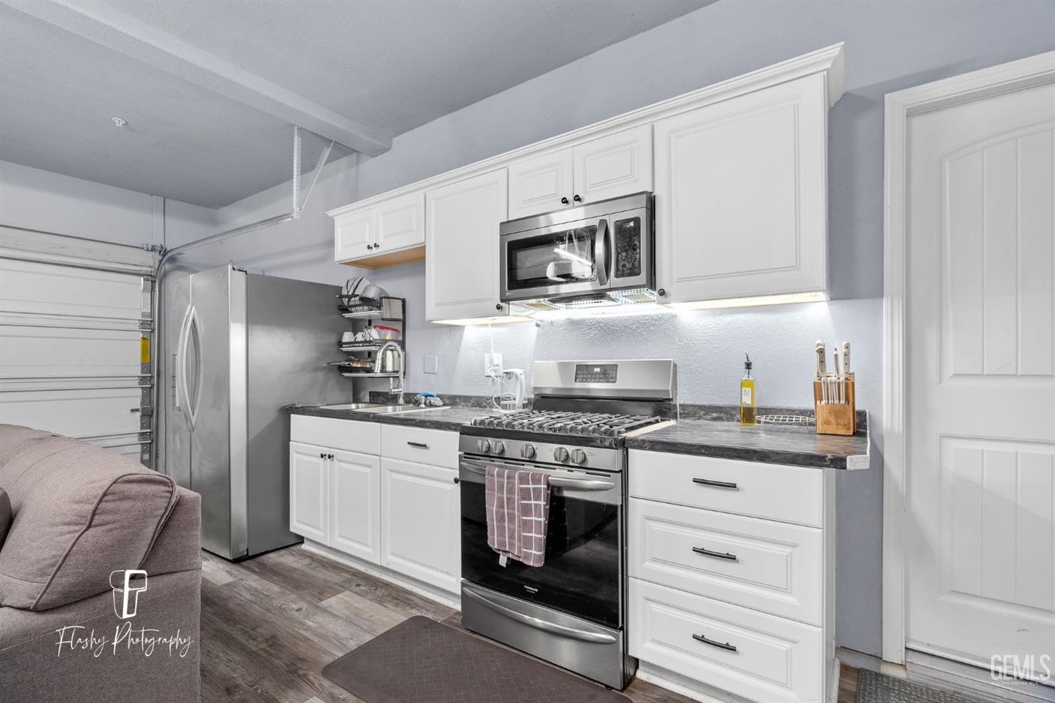 Undisclosed Address Bakersfield, CA 93313 - Photo 33 of 36 a kitchen with stainless steel appliances granite countertop a stove and a refrigerator