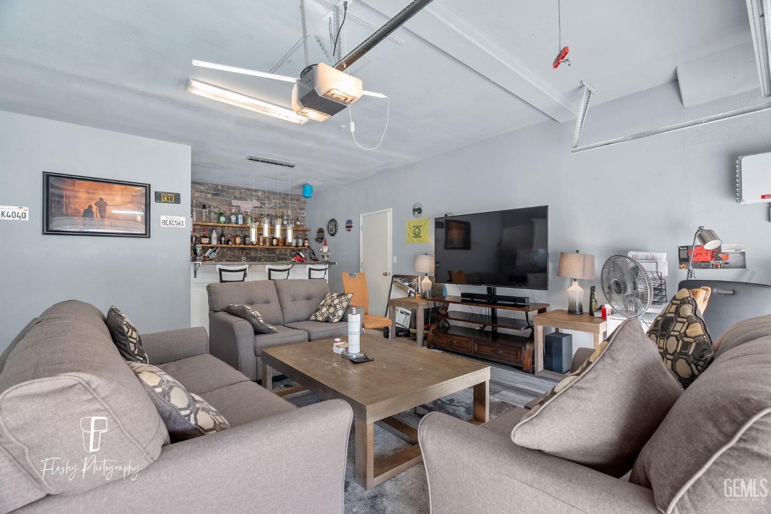 Undisclosed Address Bakersfield, CA 93313 - Photo 5 of 36 a living room with furniture and a flat screen tv