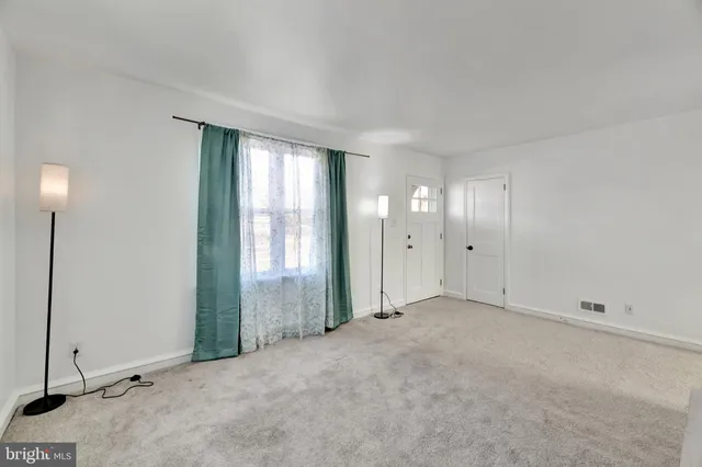 an empty room with windows and closet