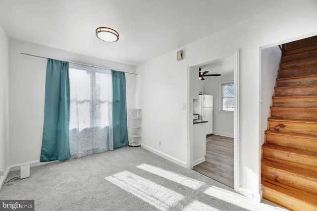 a view of a hallway with wooden floor and entryway