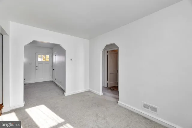 an empty room with windows and closet