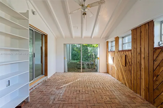 a view of a house with a yard and large trees