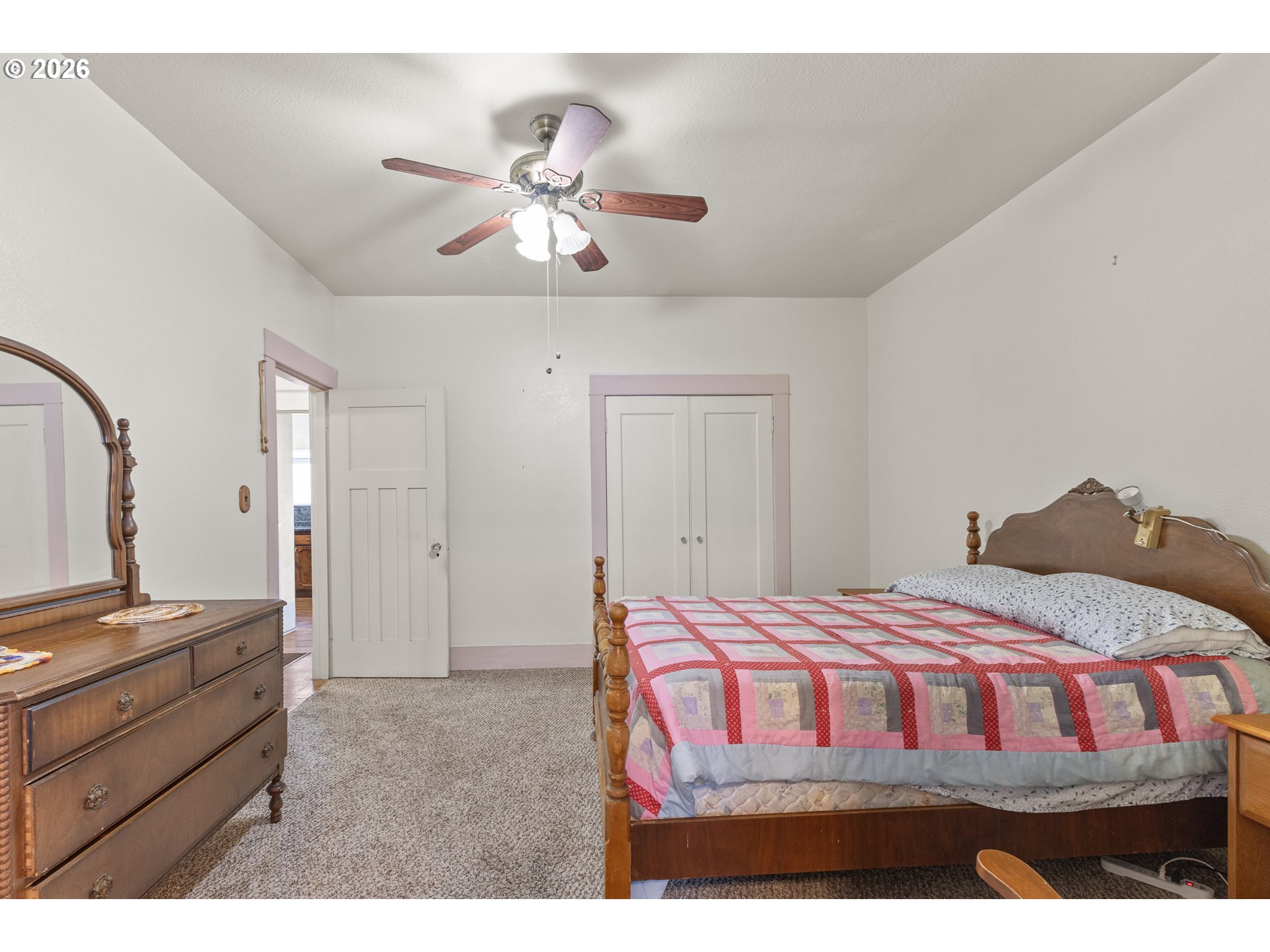 208 7th Street Myrtle Point, OR 97458 - Photo 30 of 48 a bedroom with a bed and a chandelier