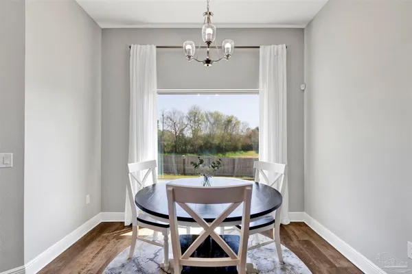 a view of a dining room with furniture window and wooden floor
