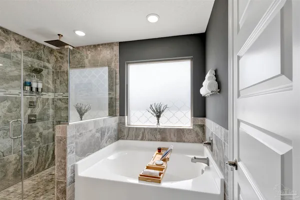 a bathroom with a bathtub and a shower