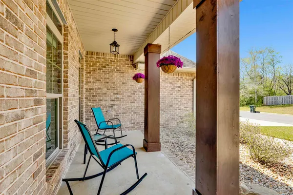 a view of front door of house with outdoor seating