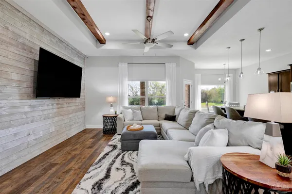 a living room with furniture a flat screen tv and a fireplace