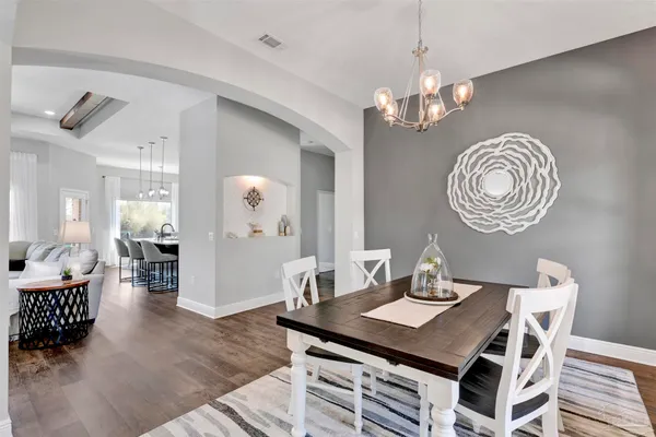 a view of a dining room with furniture and chandelier