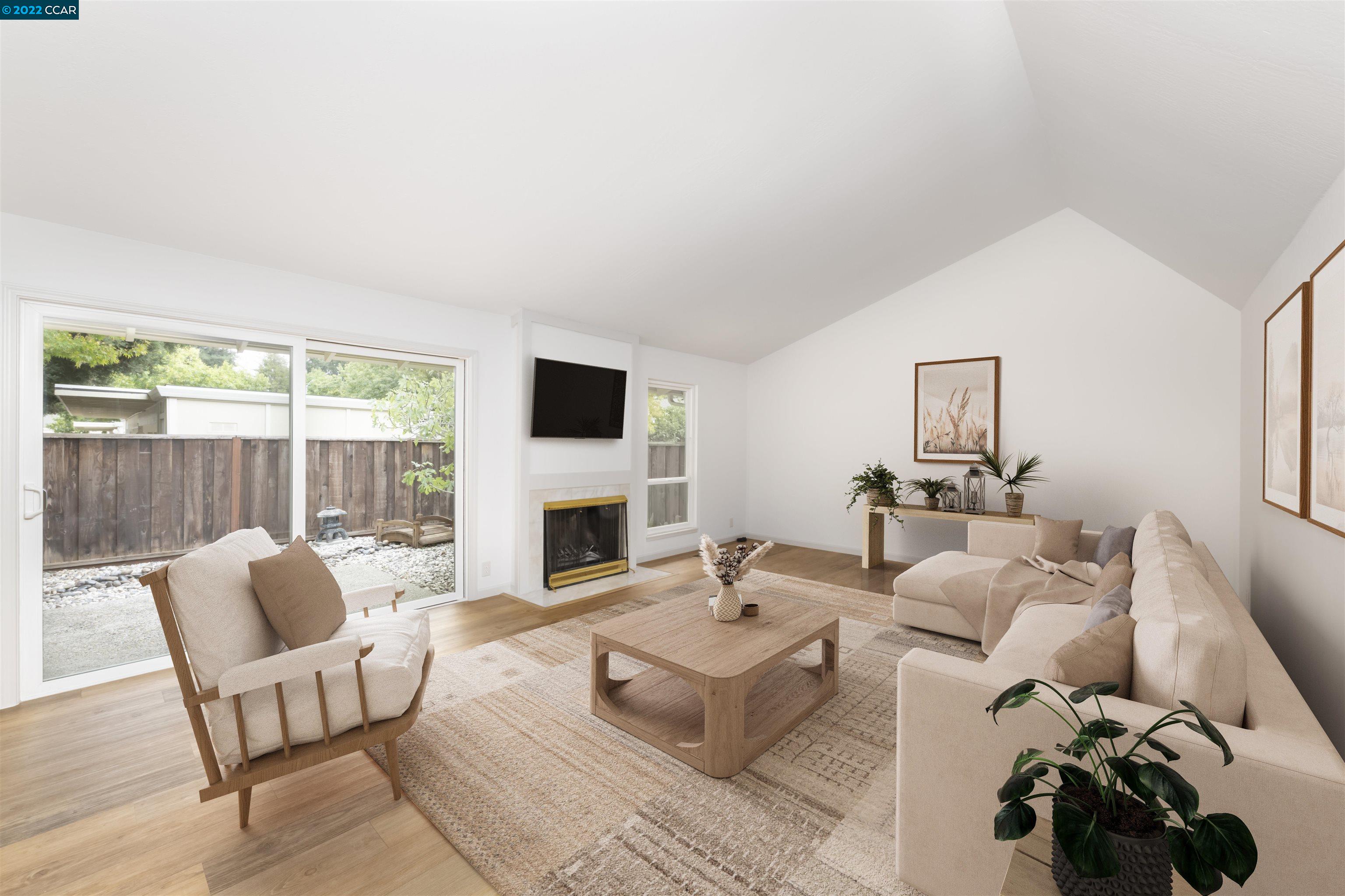 a living room with furniture a fireplace and a floor to ceiling window
