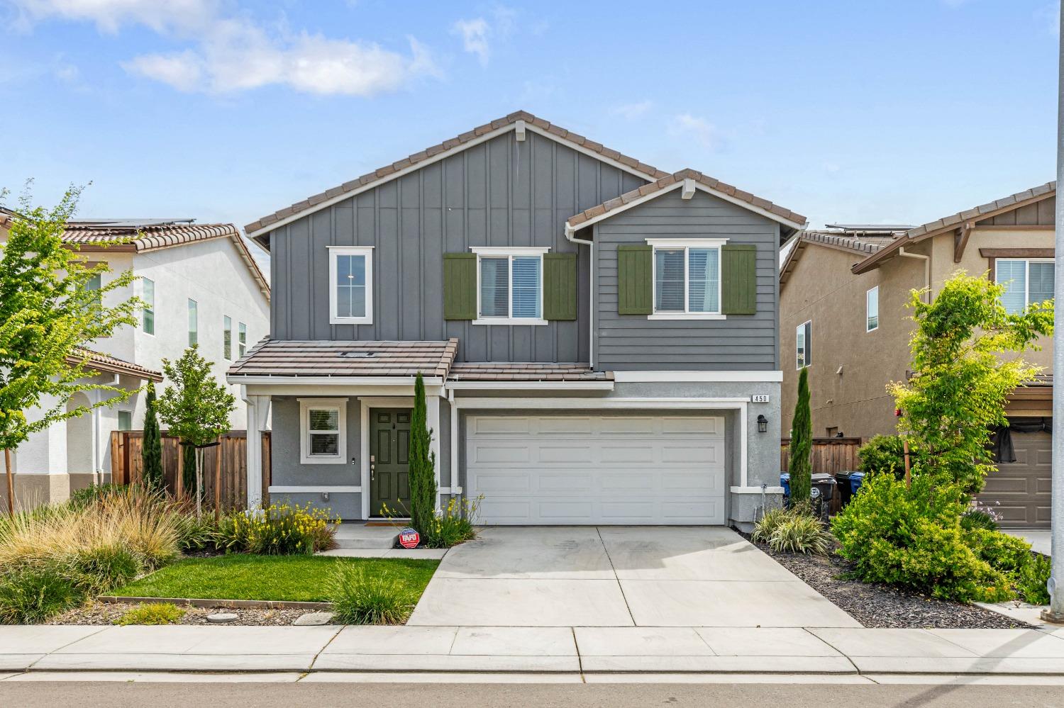 a front view of a house with a yard and garage