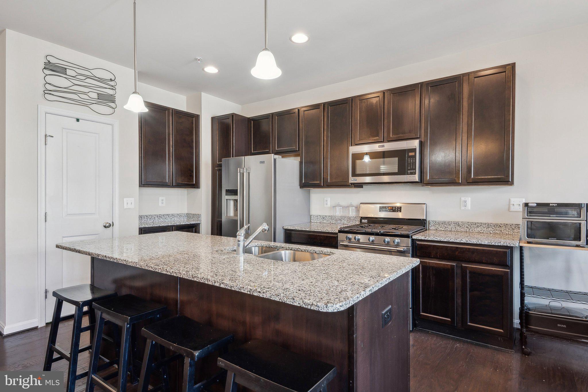 58 Mustang Drive La Plata, MD 20646 - Photo 11 of 42 a kitchen with kitchen island a sink stove and refrigerator