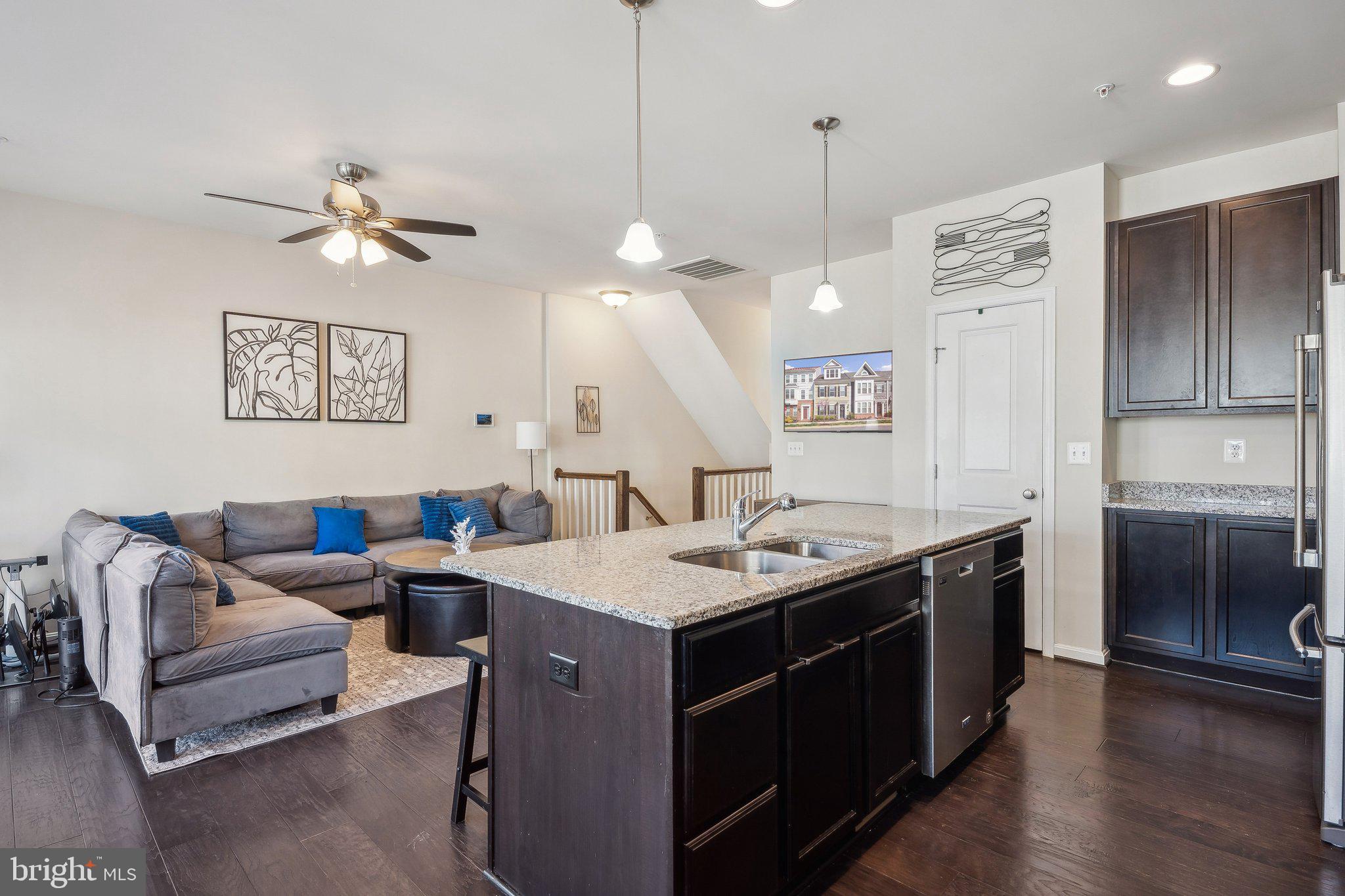 58 Mustang Drive La Plata, MD 20646 - Photo 12 of 42 a living room with stainless steel appliances kitchen island a table chairs and a refrigerator