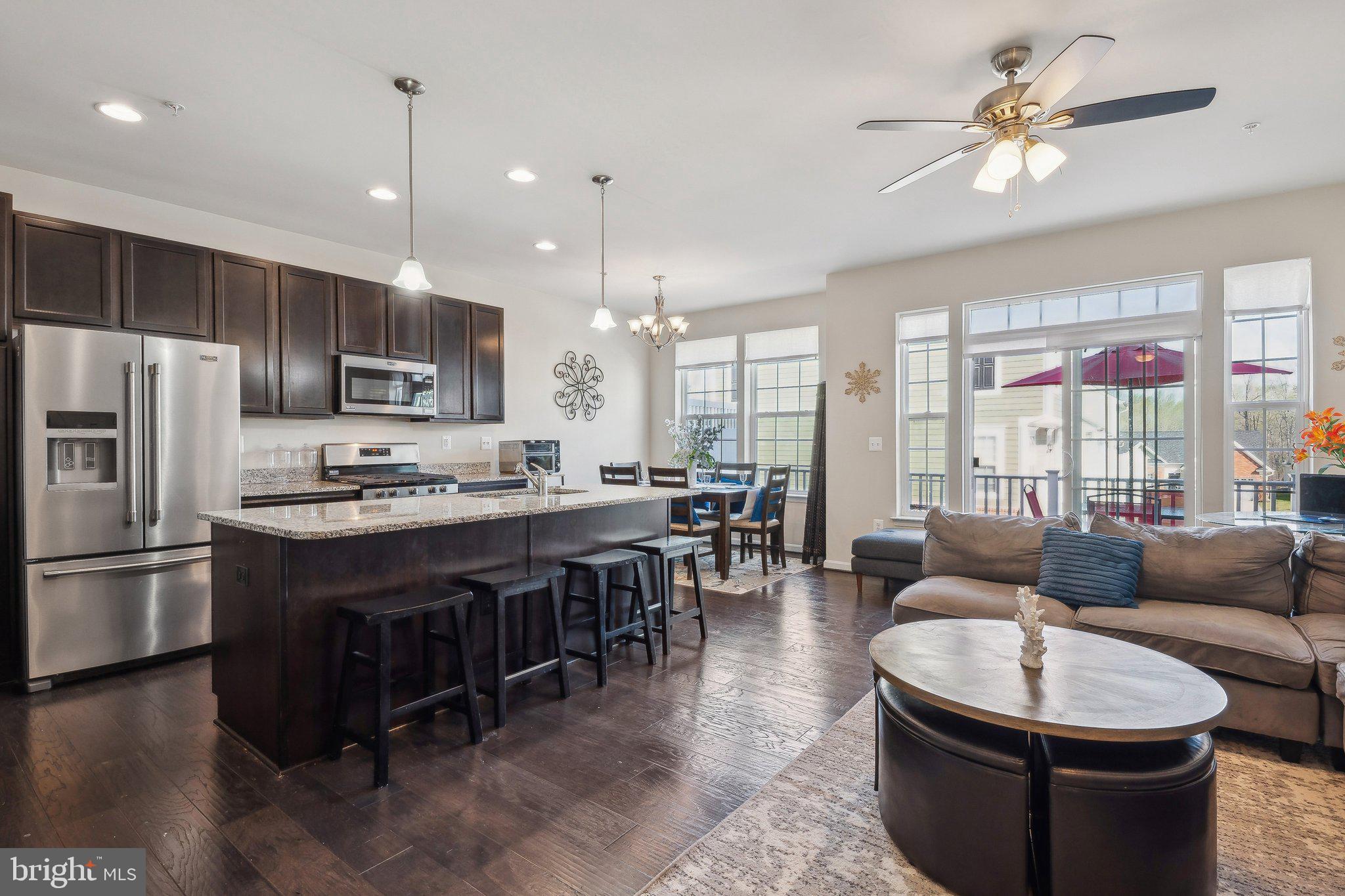 58 Mustang Drive La Plata, MD 20646 - Photo 8 of 42 a large kitchen with kitchen island a large counter space stainless steel appliances and a chandelier