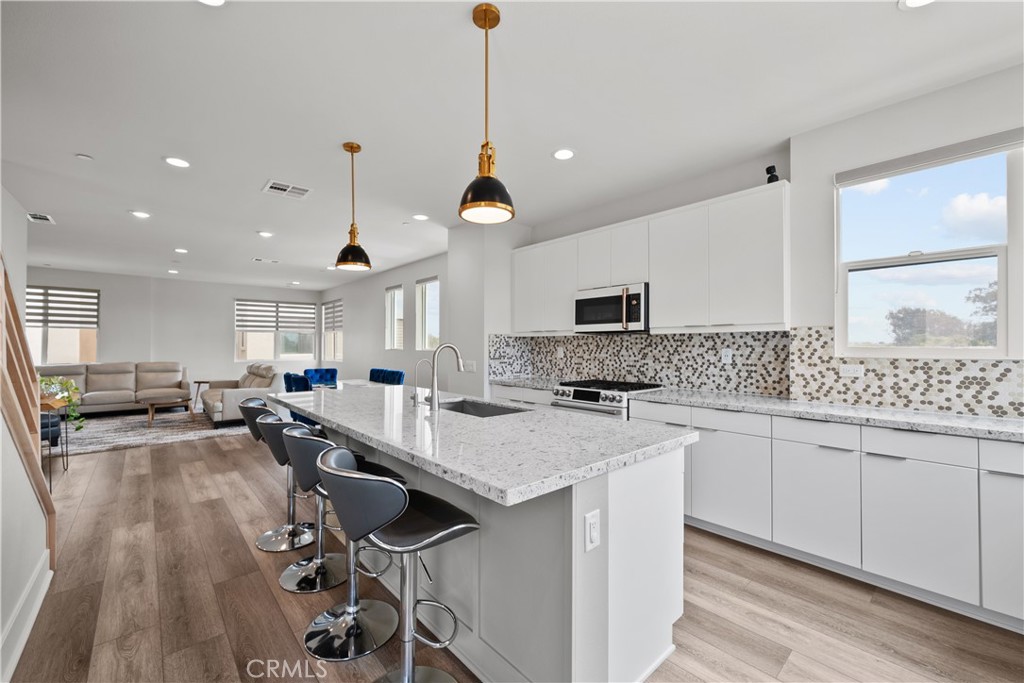 1068 Canal Street Oxnard, CA 93035 - Photo 11 of 36 a kitchen with a sink a counter space appliances and cabinets