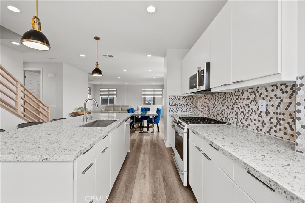1068 Canal Street Oxnard, CA 93035 - Photo 12 of 36 a large kitchen with granite countertop a sink and a stove top oven