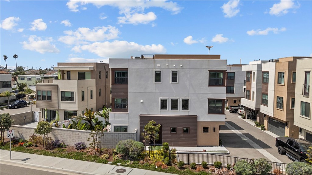 1068 Canal Street Oxnard, CA 93035 - Photo 13 of 36 a view of a white building among the street with palm trees