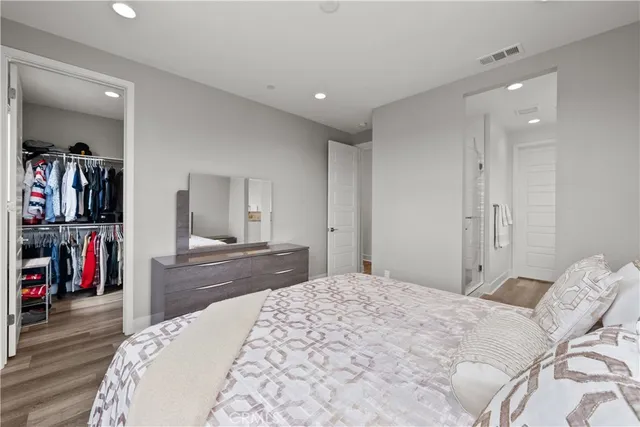 a bedroom with a large bed and a window