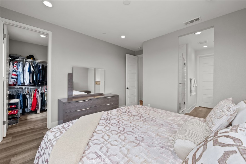 1068 Canal Street Oxnard, CA 93035 - Photo 17 of 36 a bedroom with a bed and a large mirror