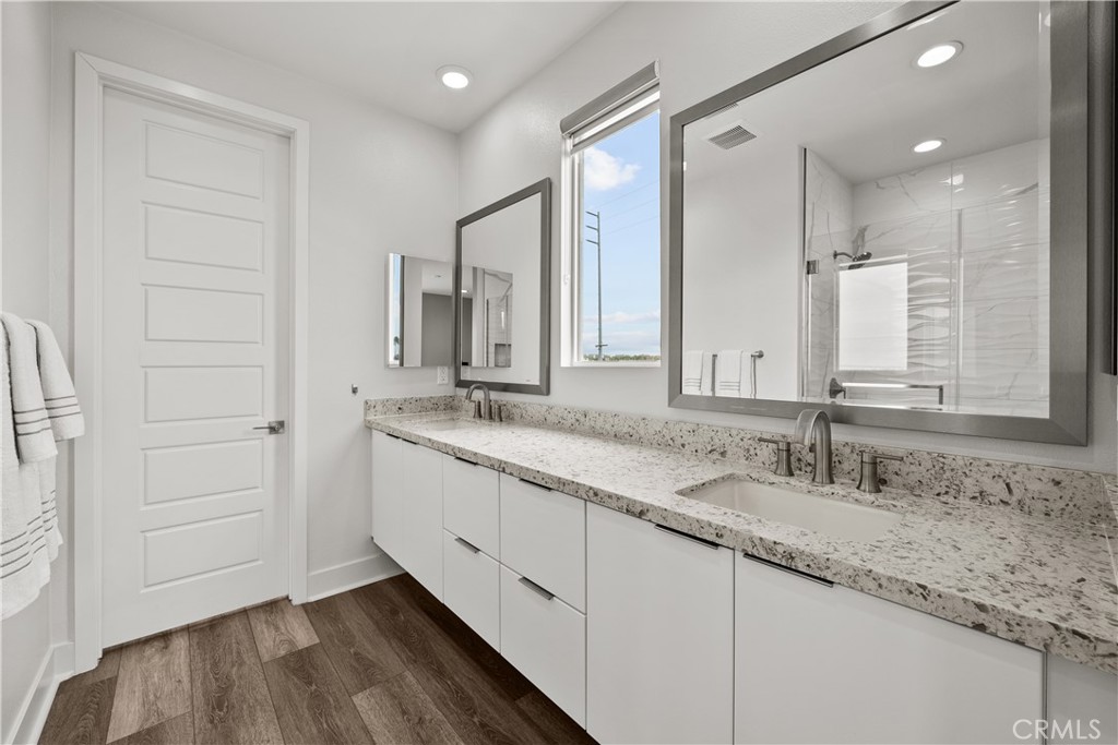 1068 Canal Street Oxnard, CA 93035 - Photo 19 of 36 a bathroom with double sink and a mirror