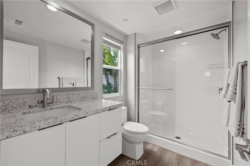 1068 Canal Street Oxnard, CA 93035 - Photo 25 of 36 a bathroom with a granite countertop sink toilet and shower
