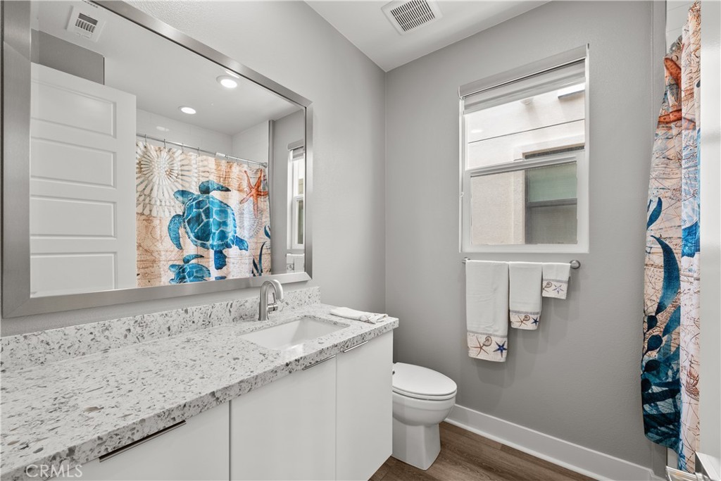 1068 Canal Street Oxnard, CA 93035 - Photo 28 of 36 a bathroom with a granite countertop sink and a mirror