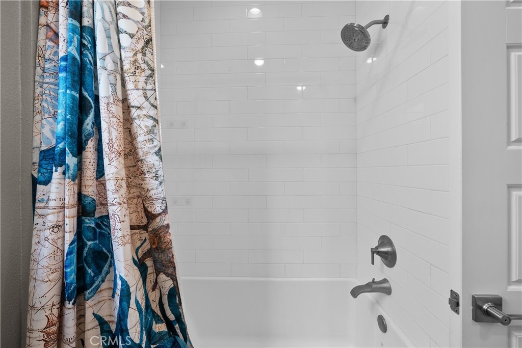 1068 Canal Street Oxnard, CA 93035 - Photo 29 of 36 a bathroom with a bathtub and shower