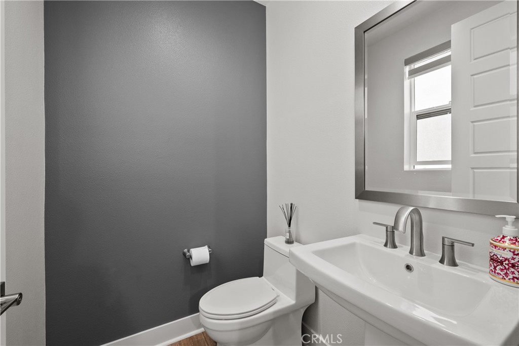 1068 Canal Street Oxnard, CA 93035 - Photo 30 of 36 a white toilet sitting next to a bathroom sink