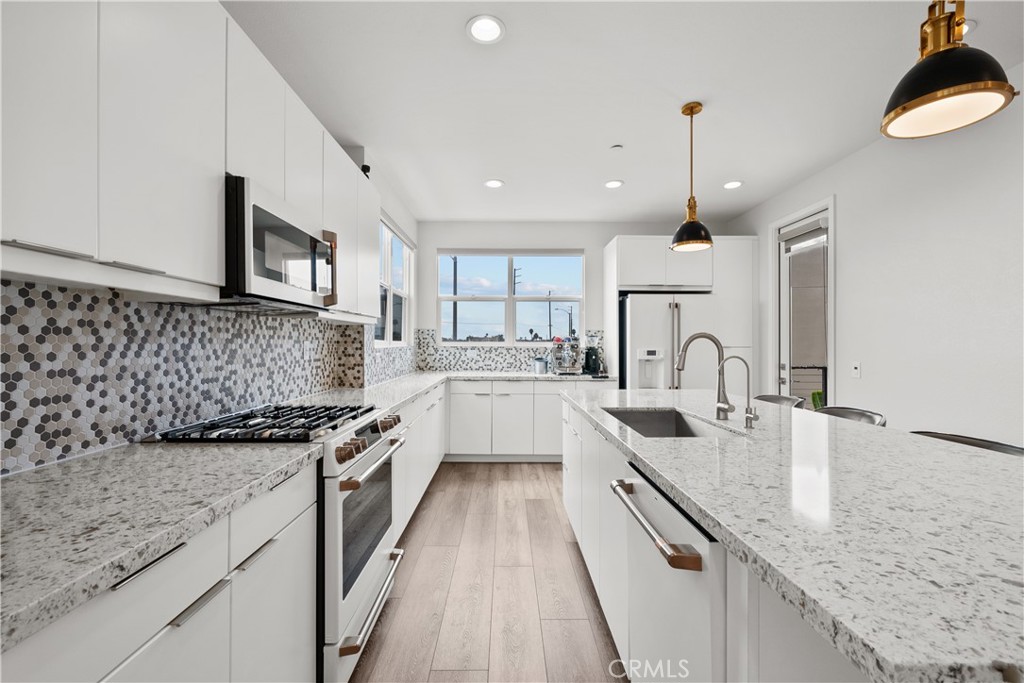 1068 Canal Street Oxnard, CA 93035 - Photo 8 of 36 a kitchen with stainless steel appliances granite countertop sink stove and cabinets