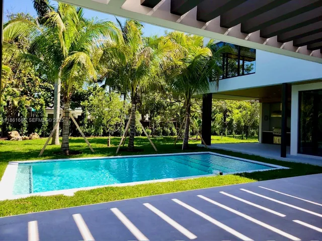 a bathroom with a double vanity sink toilet mirror and bathtub