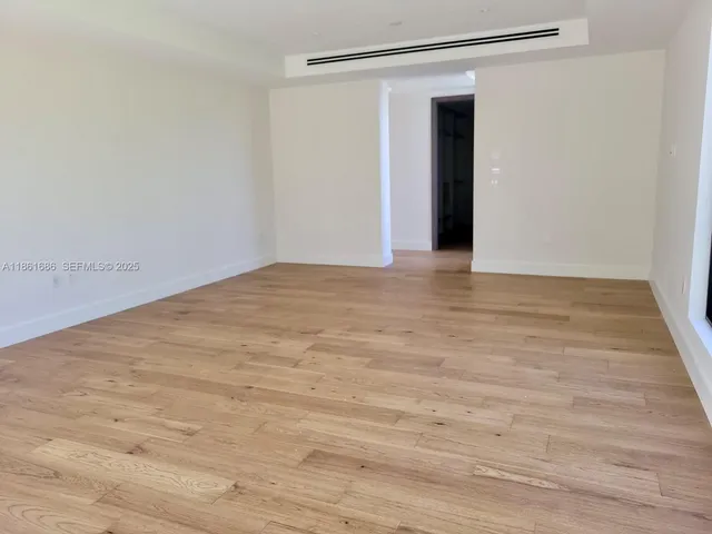 a view of a room with wooden floor and doors