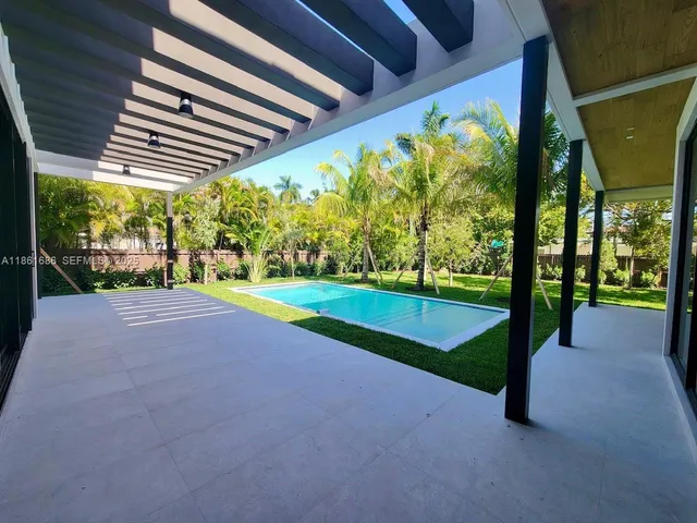 a swimming pool with outdoor seating and yard